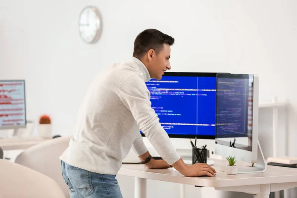 Male programmer working in office