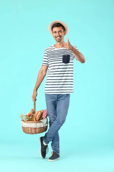 Young Man Food Picnic Basket Showing Thumb Gesture Color Background — Stock Photo, Image