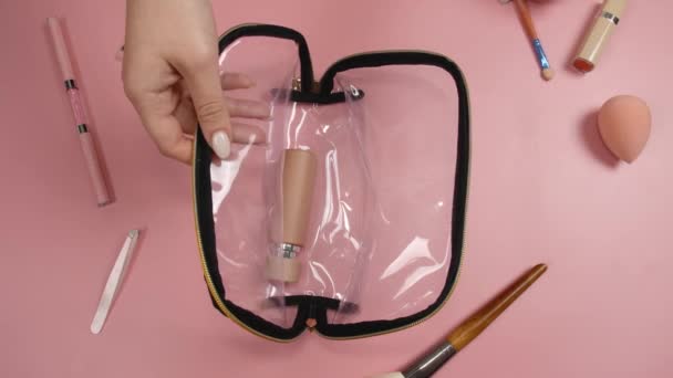 Mujer Poniendo Cosméticos Maquillaje Accesorios Bolso Fondo Color Vista Superior — Vídeo de stock