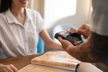 Lokantada faturasını ödeyen kadın.