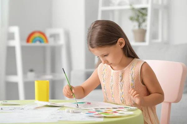 Cute little girl coloring pictures at home