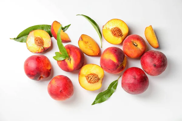 Sweet ripe peaches on white background