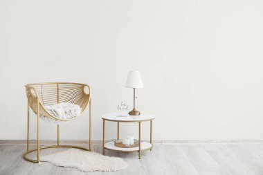 Şık bir koltuk ve ışık duvarının yanındaki masa.