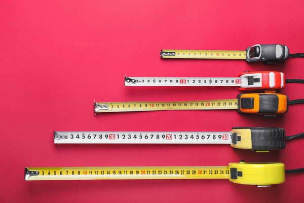 Measuring tapes on color background