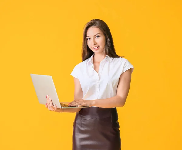 Schöne Junge Geschäftsfrau Mit Laptop Auf Farbigem Hintergrund — Stockfoto