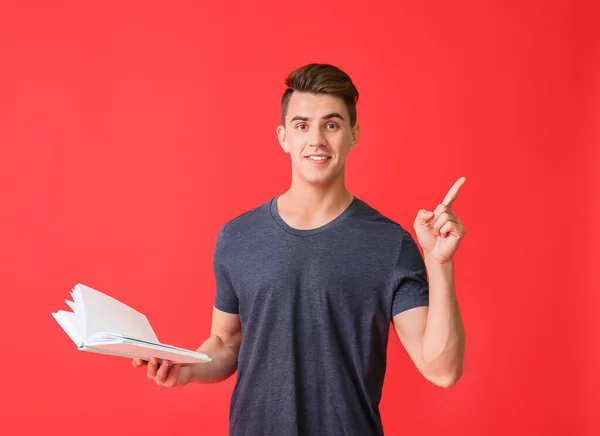 Handsome Young Man Book Raised Index Finger Color Background — Stock Photo, Image