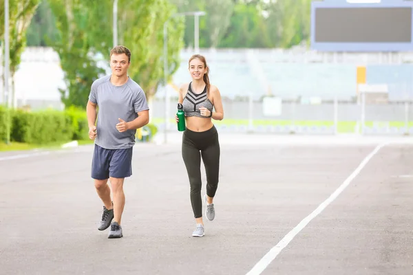 Sporty Young Couple Running Outdoors — Stock Photo, Image