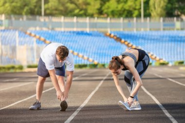 Stadyumda genç çiftler antrenman yapıyor.