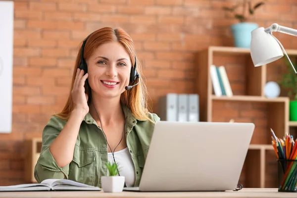 Woman with headset working in office