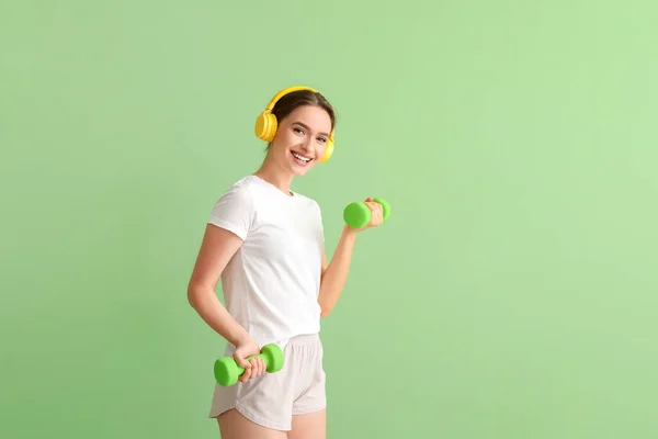 Sporty Young Woman Headphones Dumbbells Color Background — Stock Photo, Image