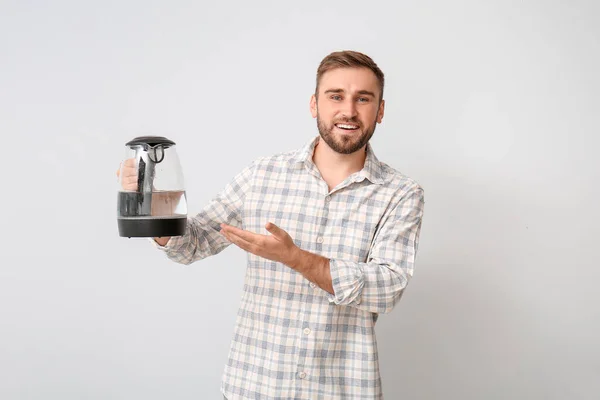 Young Man Electric Kettle Light Background — Stock Photo, Image