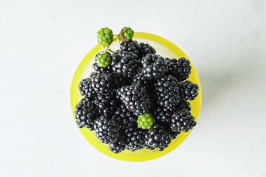 Beyaz arka planda lezzetli böğürtlenli fincan