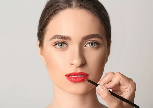 Makeup Artist Working Beautiful Young Woman Light Background — Stock Photo, Image