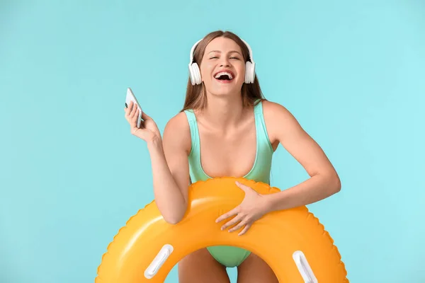 Young Woman Headphones Inflatable Ring Mobile Phone Color Background — Stock Photo, Image