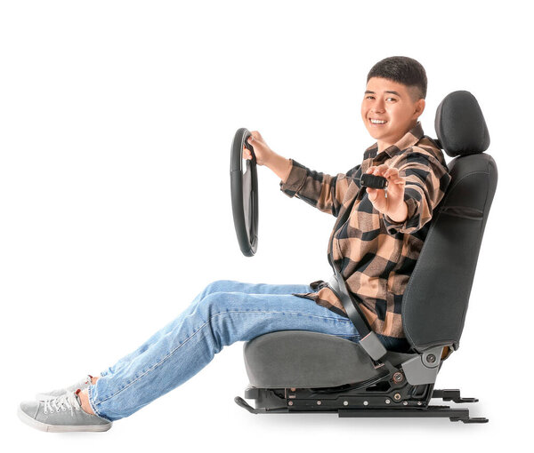 Asian man with steering wheel and key sitting on car seat against white background