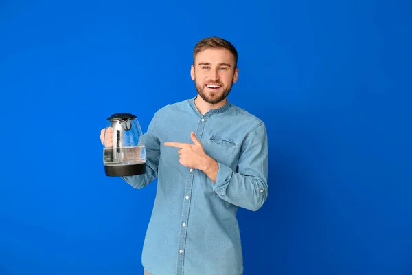 Young Man Electric Kettle Color Background — Stock Photo, Image
