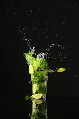 Koyu arkaplanlı bir bardak taze mojito.