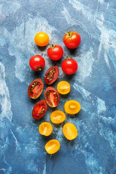 Fresh cherry tomatoes on color background