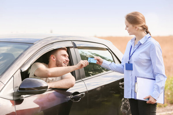 Man getting driver licence after passing test