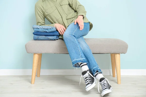 Mulher Bonita Jeans Sentado Banco Perto Parede Cor — Fotografia de Stock