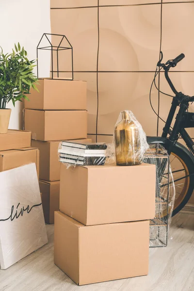 搬迁日新公寓内装有财物和自行车的纸板箱 — 图库照片