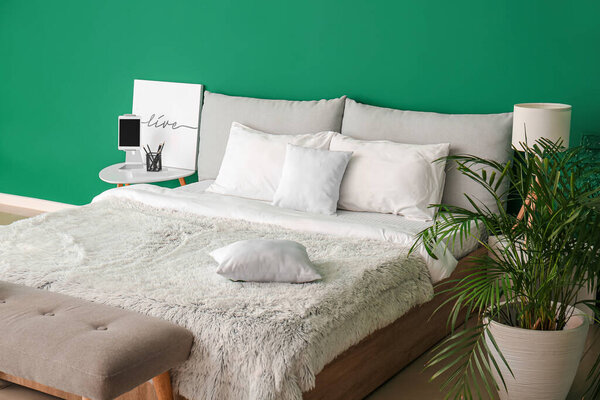 Big bed and bench in interior of modern room