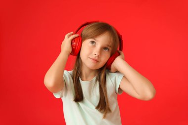 Renkli arka planda müzik dinleyen küçük kız