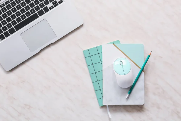 Modern laptop, PC mouse and stationery on table