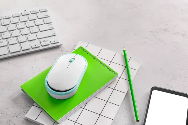 PC mouse, keyboard, smartphone and stationery on light background