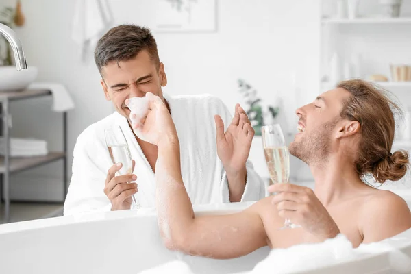 Happy Gay Couple Drinking Champagne Bathroom — Stock Photo, Image