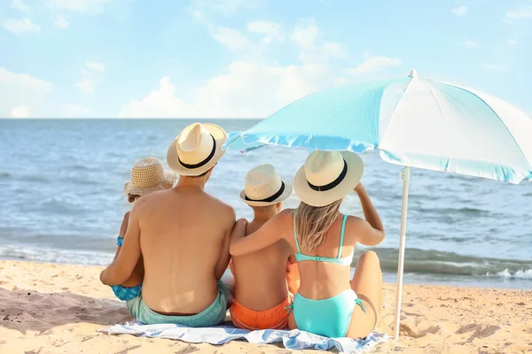 Happy family on sea beach at resort