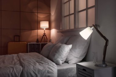 Geceleri parlayan lambaları olan modern bir otel odası.