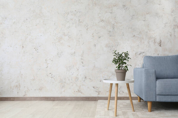 Stylish interior of living room with table and sofa