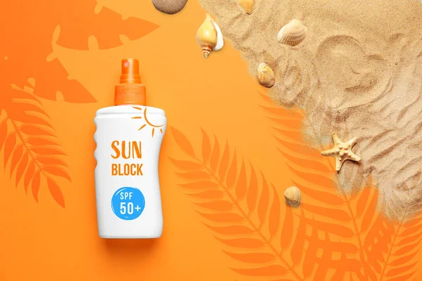 Creative composition with bottle of sunscreen cream on color background
