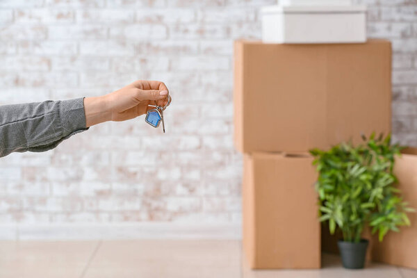Owner with key from new house indoors