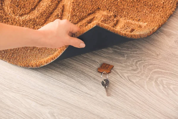 Woman Putting Spare Key Door Mat — Stock Photo, Image