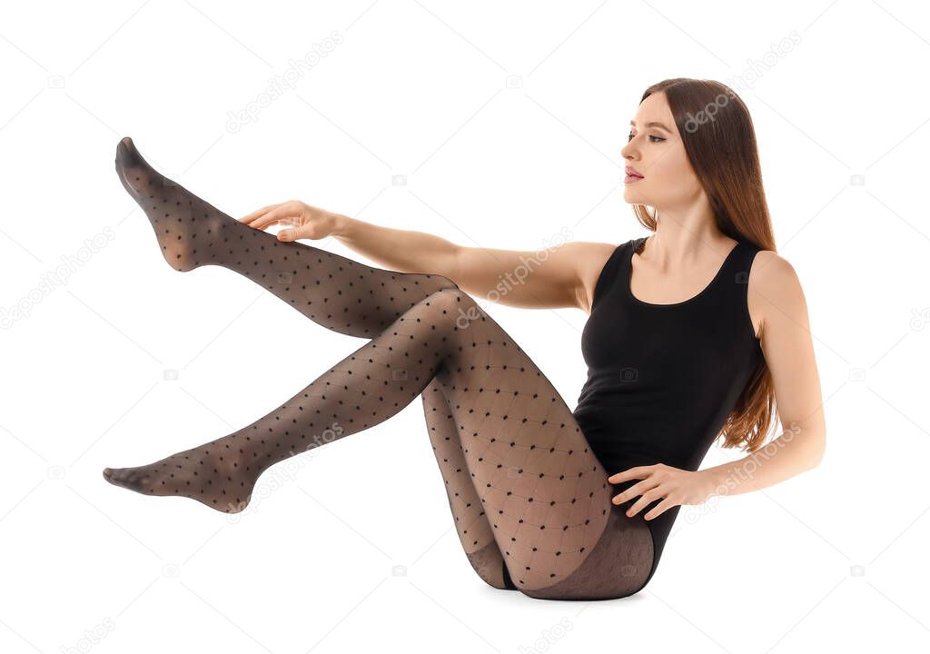 Beautiful young woman in tights on white background