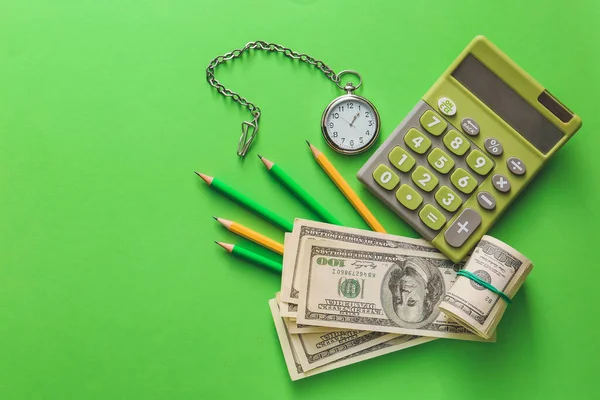 Pocket watch with calculator and money on color background