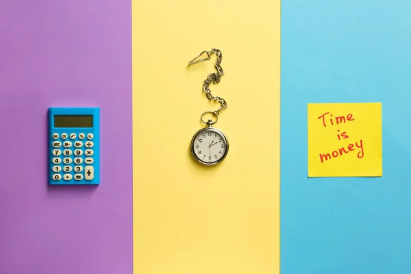 Pocket watch with calculator on color background