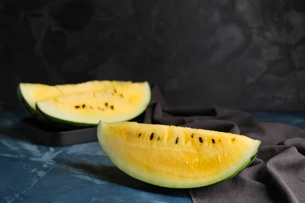 Cut yellow watermelon on table