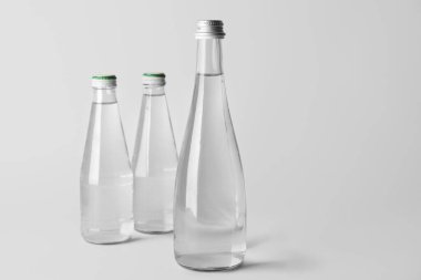 Açık arkaplanda temiz su şişeleri