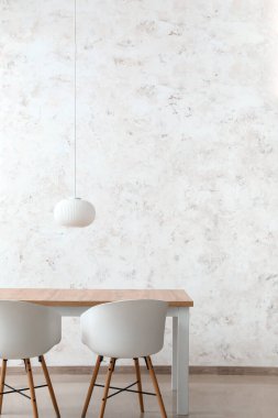 Işık duvarının yanındaki yemek masasında.