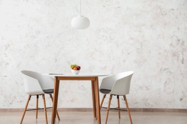 Açık duvarın yanında meyveli yemek masası.