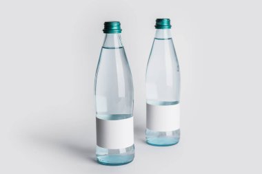 Açık arkaplanda temiz su şişeleri