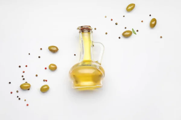 Jug of olive oil on white background