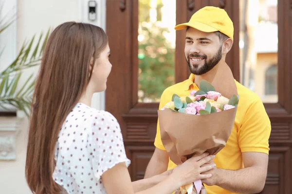 Ung Kvinna Som Tar Emot Blommor Från Kurir Utomhus — Stockfoto