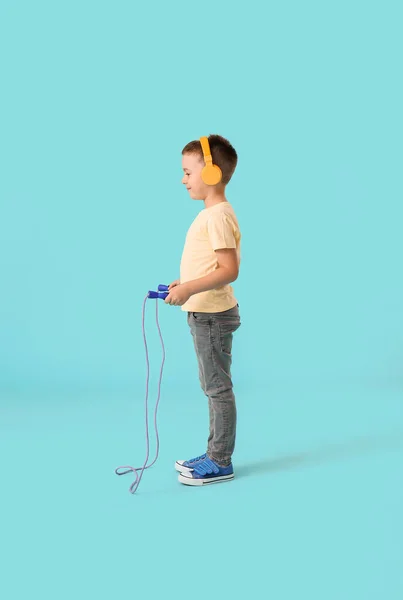 Cute Little Boy Headphones Jumping Rope Color Background — Stock Photo, Image