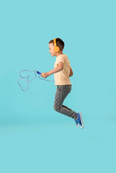 Cute Little Boy Headphones Jumping Rope Color Background — Stock Photo, Image