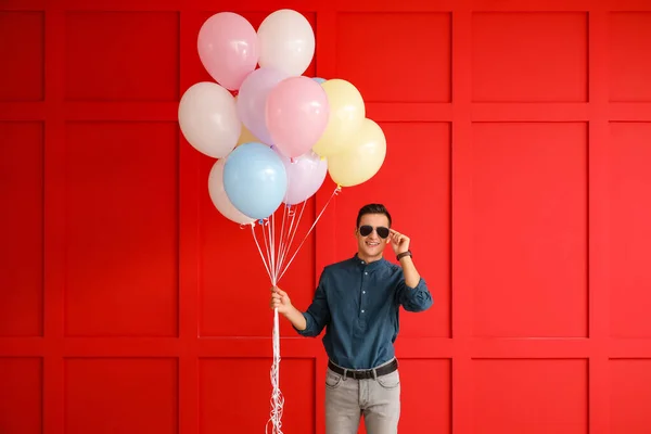 Young Man Balloons Color Background — Stock Photo, Image