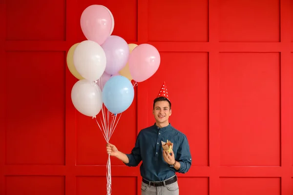 Young Man Balloons Birthday Cake Color Background — Stock Photo, Image